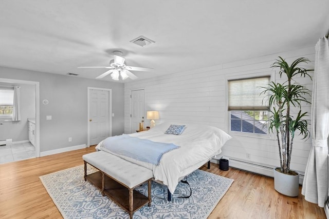 bedroom featuring visible vents, baseboards, ceiling fan, and wood finished floors