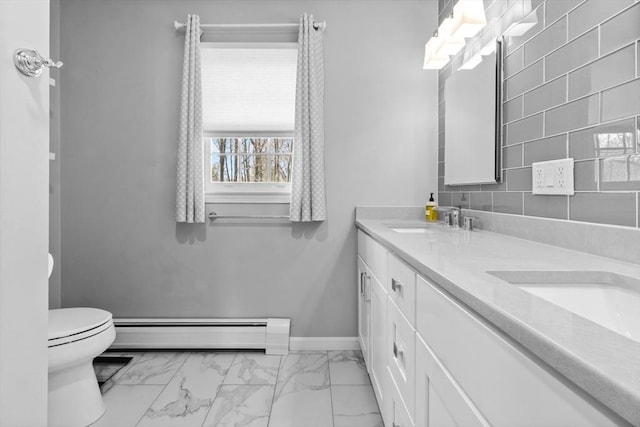 full bathroom with double vanity, a sink, a baseboard heating unit, toilet, and marble finish floor