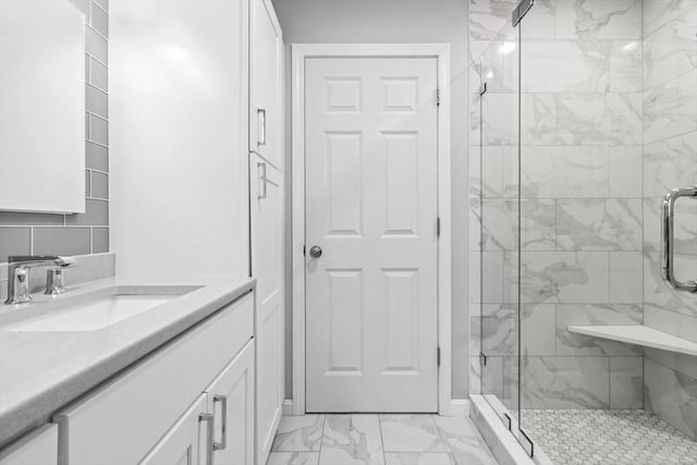 bathroom featuring vanity, marble finish floor, and a shower stall