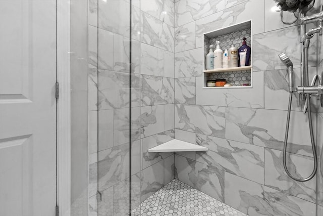 bathroom with tiled shower