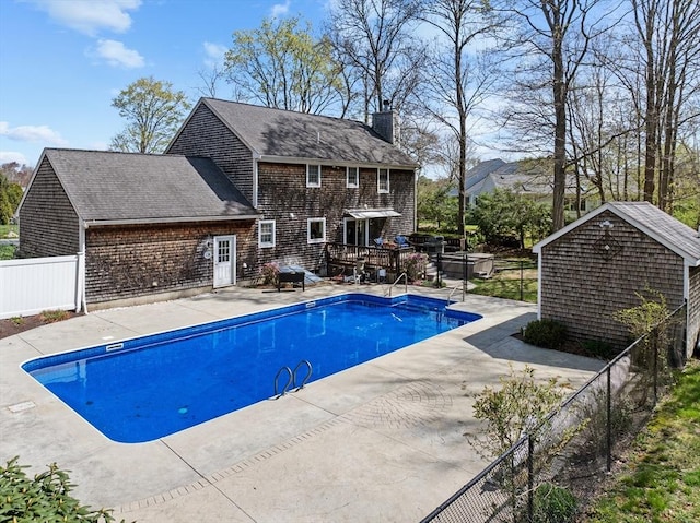 view of swimming pool featuring a hot tub, a patio, a fenced in pool, and fence