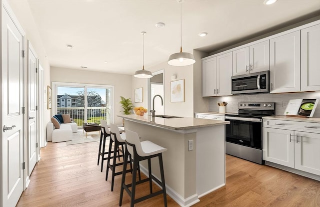 2 Codman Way Unit 305, Westborough, MA 01581 - kitchen with appliances with stainless steel finishes, a sink, recessed lighting, backsplash, and light wood finished floors