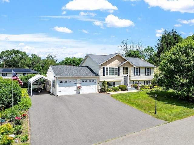 68 Victoria Ave, Athol, MA 01331 - raised ranch featuring a front yard, a garage, asphalt driveway, and a carport