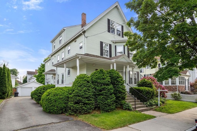 247 Ash St Unit 3, Waltham, MA 02453 - view of front facade featuring an outdoor structure, a chimney, and a garage