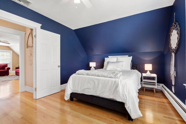 247 Ash St Unit 3, Waltham, MA 02453 - bedroom featuring lofted ceiling, baseboard heating, wood finished floors, a ceiling fan, and baseboards