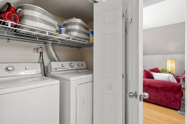 247 Ash St Unit 3, Waltham, MA 02453 - laundry room with independent washer and dryer, light wood-style floors, and baseboard heating