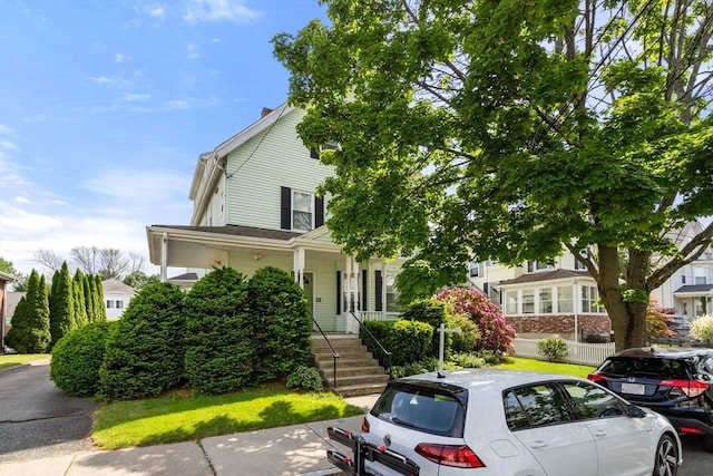 247 Ash St Unit 3, Waltham, MA 02453 - view of property hidden behind natural elements featuring a porch