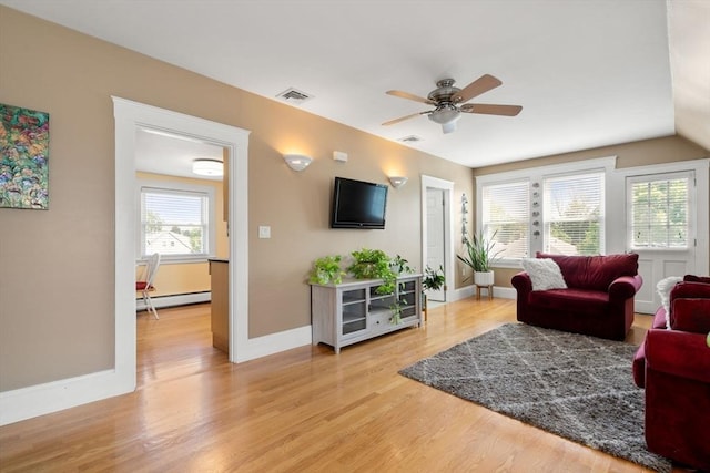 247 Ash St Unit 3, Waltham, MA 02453 - living area with a baseboard heating unit, light wood-style flooring, ceiling fan, and baseboards
