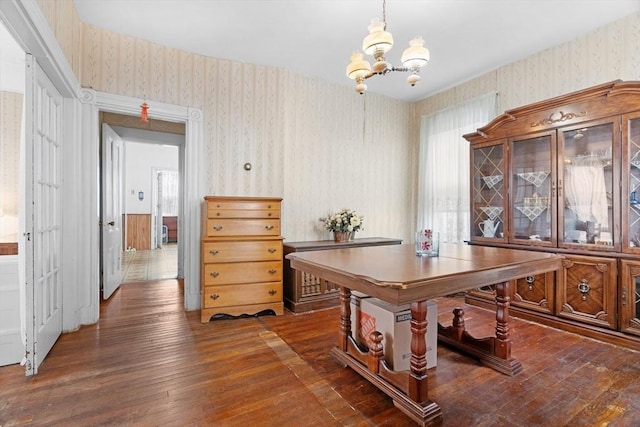 office featuring a notable chandelier, hardwood / wood-style floors, and wallpapered walls