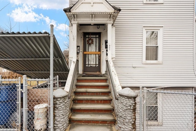 entrance to property featuring fence