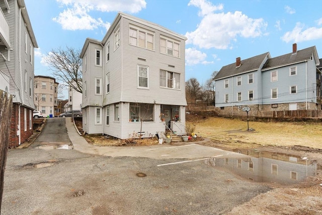 rear view of house with entry steps and a residential view