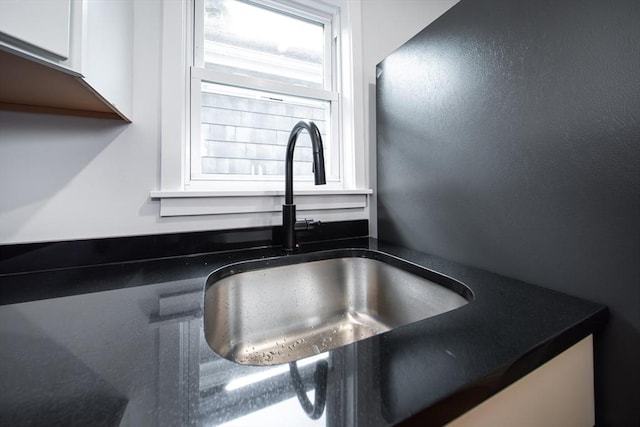 121 Horton St, Fall River, MA 02723 - kitchen view of dark countertops, white cabinets, and a sink