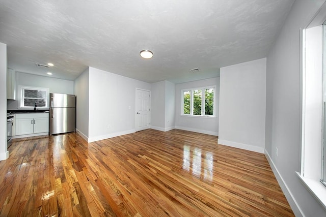 121 Horton St, Fall River, MA 02723 - unfurnished living room with baseboards, wood finished floors, a sink, and recessed lighting