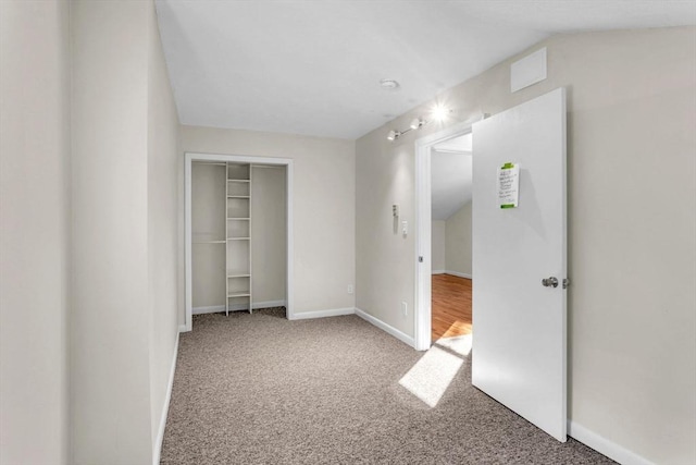 unfurnished bedroom featuring carpet floors and a closet