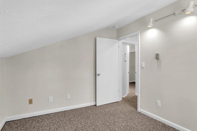 bonus room with carpet flooring and vaulted ceiling