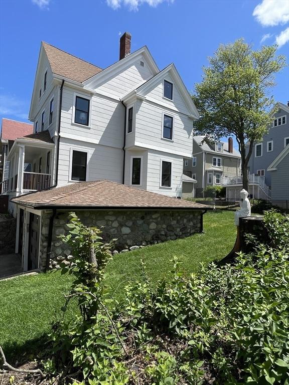 269 Main St, Melrose, MA 02176 - view of property exterior with a chimney, roof with shingles, and a yard