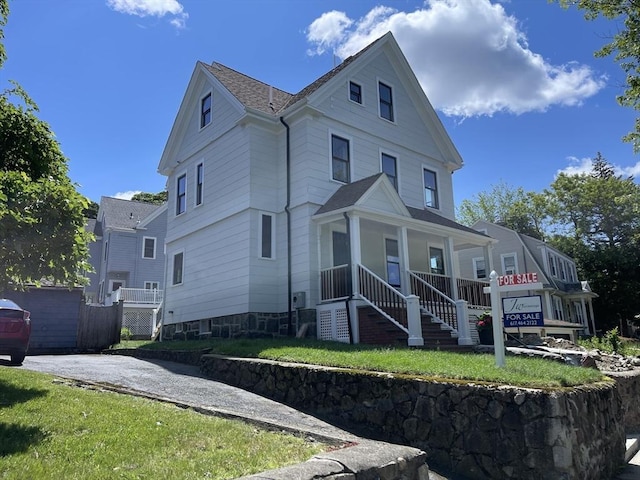 269 Main St, Melrose, MA 02176 - view of front of house featuring covered porch, stairs, and roof with shingles