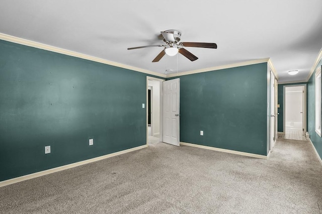 carpeted spare room featuring ornamental molding and ceiling fan