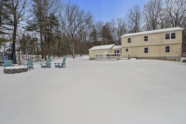 yard layered in snow with a fire pit