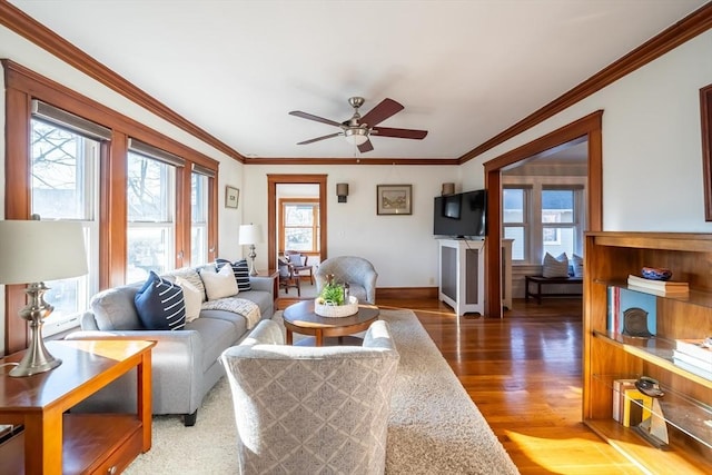 living room featuring ceiling fan, ornamental molding, and hardwood / wood-style floors