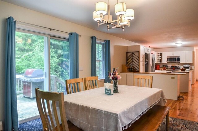 169 Lyman Rd, Berlin, MA 01503 - dining space with light wood-type flooring and a chandelier