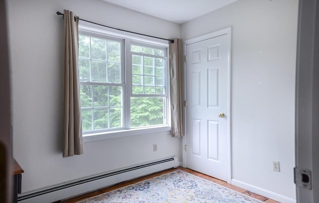 169 Lyman Rd, Berlin, MA 01503 - unfurnished bedroom with a baseboard radiator, multiple windows, and wood finished floors