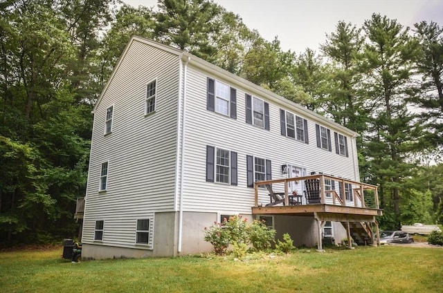 169 Lyman Rd, Berlin, MA 01503 - back of property with a lawn, a deck, and view of scattered trees