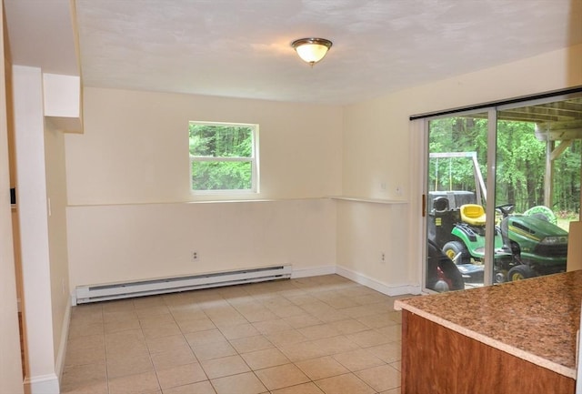 169 Lyman Rd, Berlin, MA 01503 - unfurnished dining area featuring a baseboard radiator, healthy amount of natural light, and light tile patterned flooring