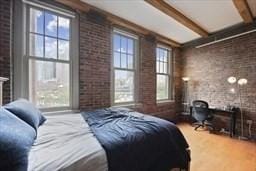 26 Stillman St Unit 4-5, Boston, MA 02113 - bedroom with a fireplace, beamed ceiling, and brick wall