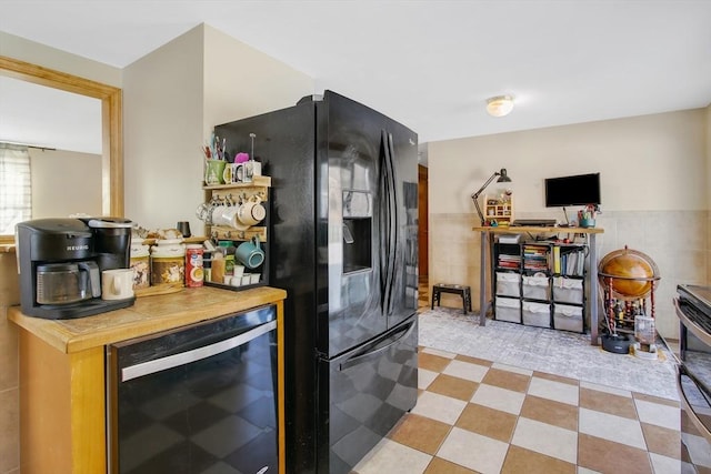 kitchen featuring wooden counters, black fridge with ice dispenser, wine cooler, and tile walls