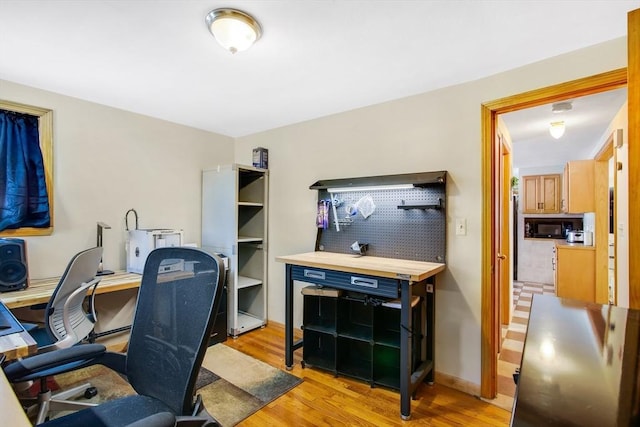 office area with light hardwood / wood-style flooring