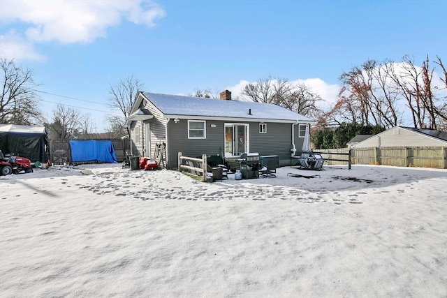 view of snow covered back of property