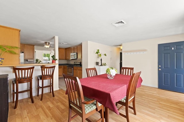dining space featuring light wood-type flooring