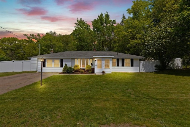 single story home with concrete driveway and a chimney