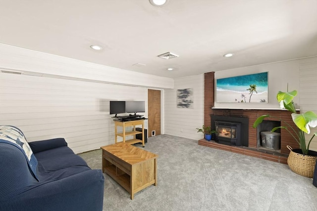 carpeted living area with a brick fireplace and recessed lighting