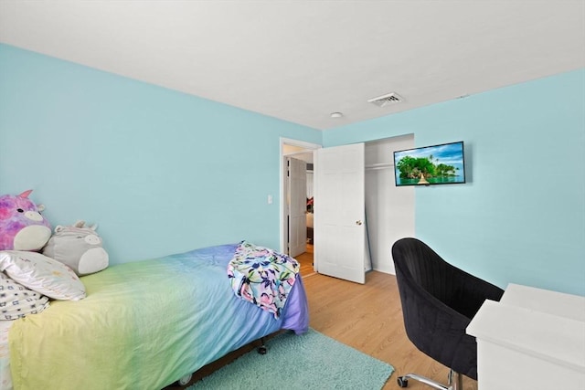 bedroom with light wood-style floors and a closet