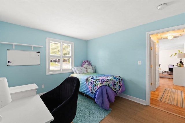 bedroom with wood finished floors and baseboards