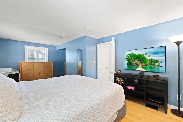 bedroom with light wood-style floors and baseboards