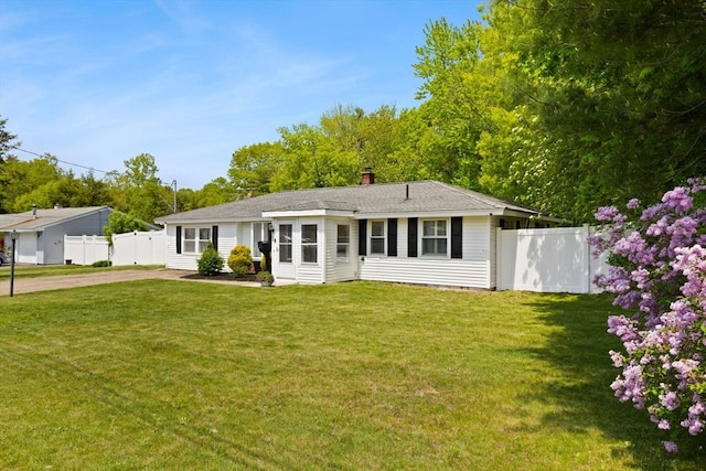 view of front of home featuring driveway and a chimney