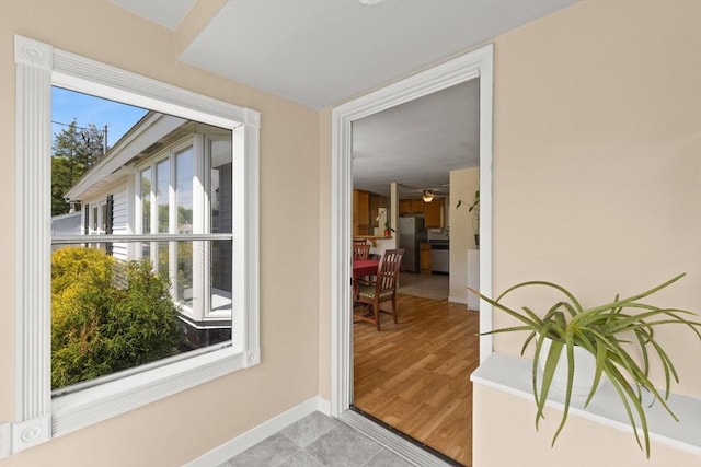 doorway to outside featuring ceiling fan and baseboards