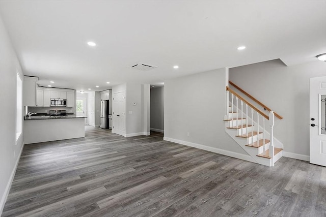 572 Pleasant St, Athol, MA 01331 - unfurnished living room featuring wood finished floors, stairs, and recessed lighting