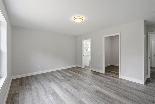 572 Pleasant St, Athol, MA 01331 - unfurnished bedroom featuring wood finished floors and connected bathroom