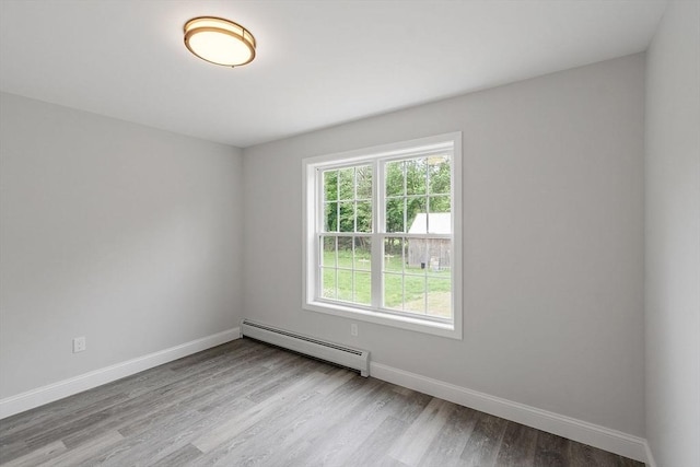 572 Pleasant St, Athol, MA 01331 - empty room featuring a baseboard radiator and wood finished floors
