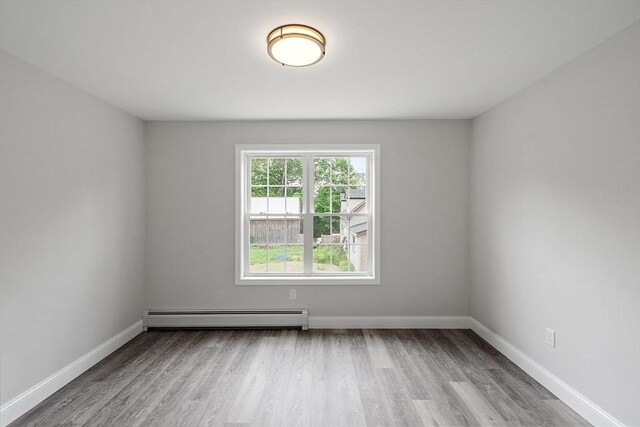 572 Pleasant St, Athol, MA 01331 - spare room featuring baseboard heating and wood finished floors