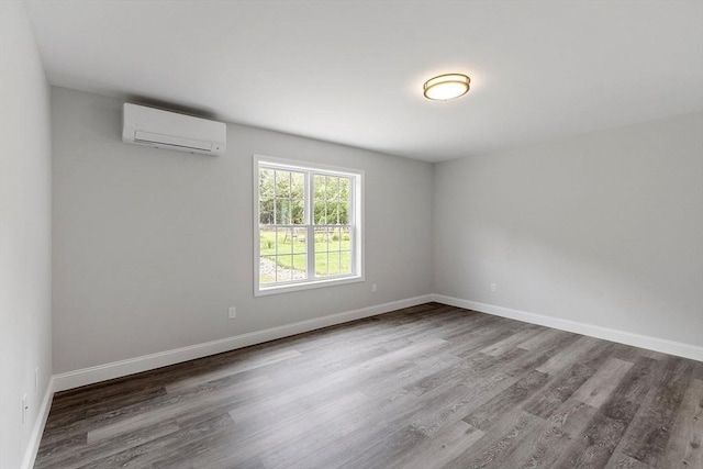 572 Pleasant St, Athol, MA 01331 - spare room with a wall mounted AC and wood finished floors