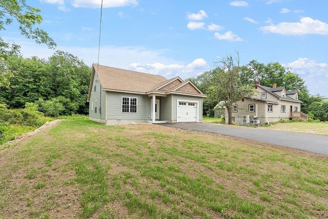 572 Pleasant St, Athol, MA 01331 - view of front of house featuring an attached garage, driveway, and a front yard