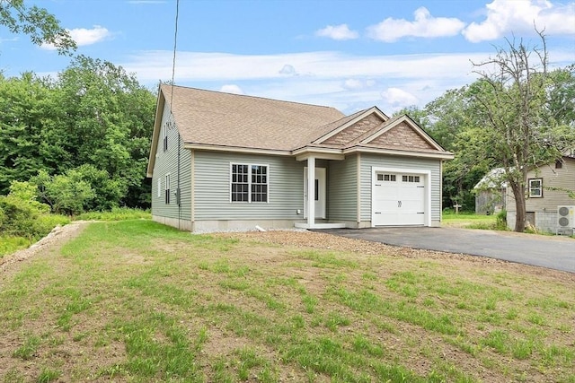 572 Pleasant St, Athol, MA 01331 - view of front facade with a garage, asphalt driveway, a front lawn, and a shingled roof
