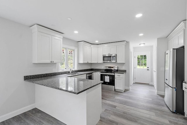 572 Pleasant St, Athol, MA 01331 - kitchen featuring appliances with stainless steel finishes, white cabinetry, recessed lighting, and a peninsula