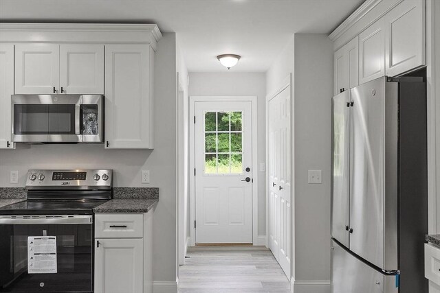 572 Pleasant St, Athol, MA 01331 - kitchen with stainless steel appliances, light wood finished floors, and white cabinets