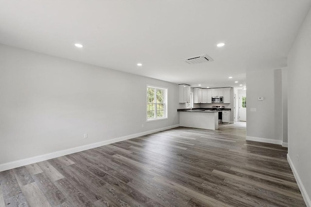 572 Pleasant St, Athol, MA 01331 - unfurnished living room featuring dark wood finished floors and recessed lighting